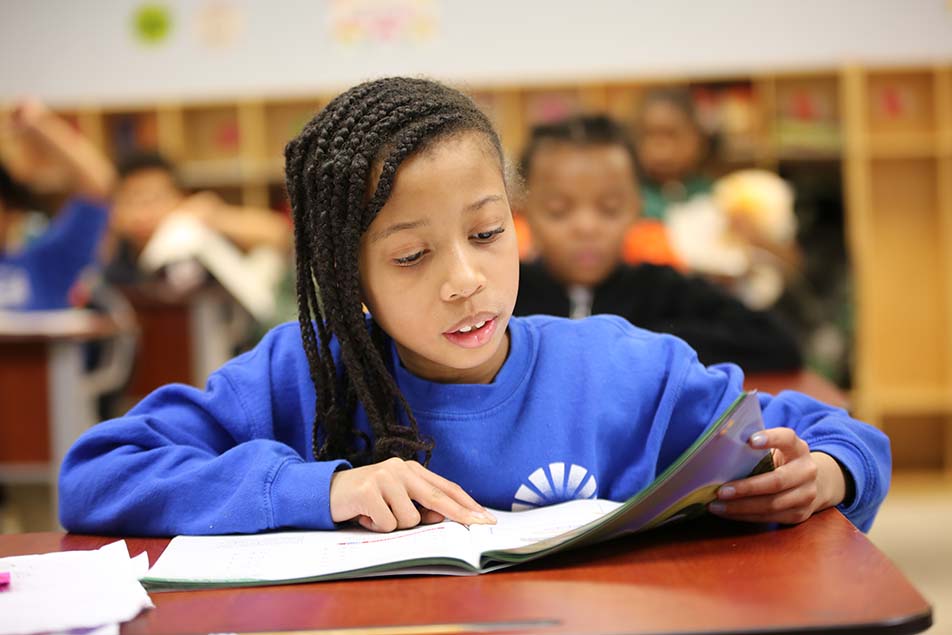 students and teacher working in classroom