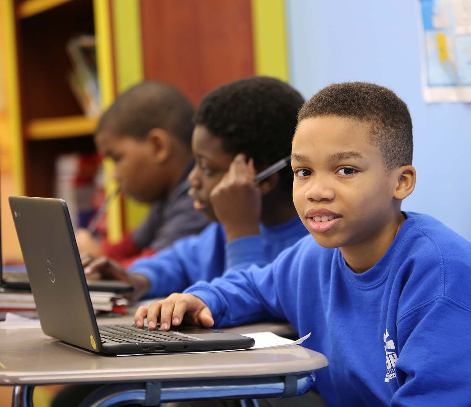 Horizon Science Academy Cleveland Elementary student wearing headphones uses a laptop in class